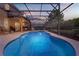 Relaxing screened-in pool and spa with an outdoor lounge area, perfect for entertaining and enjoying warm days at 5172 Oakbourne Ave, Davenport, FL 33837