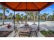 Shaded outdoor seating area with a table and chairs next to the community pool at 5172 Oakbourne Ave, Davenport, FL 33837