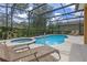 Backyard pool and jacuzzi enclosed by screened in patio at 5172 Oakbourne Ave, Davenport, FL 33837