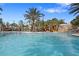 Resort-style pool featuring a slide, lounge chairs and palm trees at 5172 Oakbourne Ave, Davenport, FL 33837