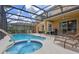 Inviting screened-in pool area with spa, lounge chairs, and an outdoor dining area, ideal for relaxation and gatherings at 5172 Oakbourne Ave, Davenport, FL 33837