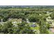 An aerial view shows the neighborhood homes surrounded by lush green trees at 5430 Nw 55Th Pl, Ocala, FL 34482