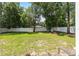 A large, green backyard featuring a well-maintained lawn and a secure white fence for privacy at 5430 Nw 55Th Pl, Ocala, FL 34482