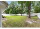 A large, green backyard featuring a well-maintained lawn and a secure white fence for privacy at 5430 Nw 55Th Pl, Ocala, FL 34482