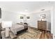 Cozy bedroom with natural light, wood floors, and comfortable furnishings at 5430 Nw 55Th Pl, Ocala, FL 34482