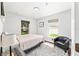 Bright bedroom with two windows, light walls, neutral rug and a comfortable queen-sized bed at 5430 Nw 55Th Pl, Ocala, FL 34482