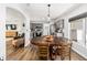 Dining area featuring a large wood table, gray cabinets, stainless steel appliances, and ample natural light at 5430 Nw 55Th Pl, Ocala, FL 34482