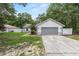 Single-story home with a two car garage, gray accents, a well-maintained lawn and a cozy, inviting entrance at 5430 Nw 55Th Pl, Ocala, FL 34482