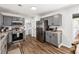 Modern kitchen featuring gray cabinets, stainless steel appliances, wood floors, and ample counter space at 5430 Nw 55Th Pl, Ocala, FL 34482