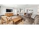 Open concept living room and kitchen area, hardwood floors, and a comfortable sofa at 5430 Nw 55Th Pl, Ocala, FL 34482