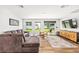 Comfortable living room with ample seating, wood floors, and backyard views through sliding glass doors at 5430 Nw 55Th Pl, Ocala, FL 34482