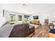 Bright living room featuring wood floors, a large window and sliding glass door, with a comfortable sofa at 5430 Nw 55Th Pl, Ocala, FL 34482