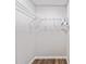 A small walk-in closet with wood-look flooring and white wire shelving, perfect for storage at 5430 Nw 55Th Pl, Ocala, FL 34482