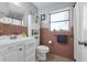Well-lit bathroom with a vanity, toilet, mirror, and decorative accents at 565 S Floyd Cir, Deltona, FL 32725