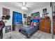 Decorated bedroom featuring a ceiling fan, a dresser, and a blue striped bedspread at 565 S Floyd Cir, Deltona, FL 32725