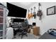 Office area with a large screen tv, desk and 3 guitars on wall at 565 S Floyd Cir, Deltona, FL 32725