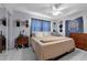 Comfortable bedroom with a queen bed, neutral tones, ample natural light, and closet at 565 S Floyd Cir, Deltona, FL 32725