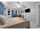 Relaxing bedroom featuring a queen bed, dresser, and mounted TV at 565 S Floyd Cir, Deltona, FL 32725