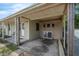 Exterior view of a car port featuring columns, concrete flooring, and adjacent porch at 565 S Floyd Cir, Deltona, FL 32725
