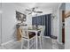 Cozy dining area with a wooden table, seating for six, stylish decor, and modern ceiling fan at 565 S Floyd Cir, Deltona, FL 32725
