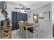 Bright dining area with a ceiling fan, a decorative chandelier, and a rustic table set at 565 S Floyd Cir, Deltona, FL 32725