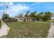 Charming single-story home featuring a welcoming front porch and covered parking at 565 S Floyd Cir, Deltona, FL 32725