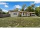 Charming single-story home featuring a welcoming front porch and covered parking at 565 S Floyd Cir, Deltona, FL 32725