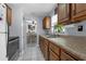 The kitchen features stainless steel appliances, wood cabinets, and a double sink at 565 S Floyd Cir, Deltona, FL 32725