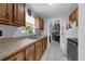 Functional kitchen with wood cabinetry, a stainless steel sink, and modern appliances at 565 S Floyd Cir, Deltona, FL 32725