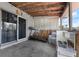 An enclosed patio with wood paneling, large windows, a treadmill and a kitchen at 565 S Floyd Cir, Deltona, FL 32725