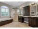 Bright bathroom featuring a garden tub, walk-in shower, and dual vanity sinks at 5740 Aloma Woods Blvd, Oviedo, FL 32765