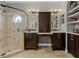 Bright bathroom with a large walk-in shower, dual vanities and custom framed mirrors at 5740 Aloma Woods Blvd, Oviedo, FL 32765