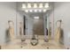 Bathroom features dual sinks, a large mirror, and neutral color palette at 5740 Aloma Woods Blvd, Oviedo, FL 32765