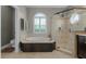 Bright bathroom features a garden tub, walk-in shower, and tiled floor at 5740 Aloma Woods Blvd, Oviedo, FL 32765