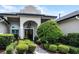 Inviting front entrance with lush landscaping and double front doors at 5740 Aloma Woods Blvd, Oviedo, FL 32765