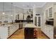 Bright kitchen with white cabinets, stainless steel appliances, and a center island at 5740 Aloma Woods Blvd, Oviedo, FL 32765