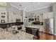Spacious kitchen with granite countertops, stainless steel appliances, custom cabinets, and wine storage at 5740 Aloma Woods Blvd, Oviedo, FL 32765