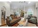 Bright living room boasting hardwood floors, high ceilings, and comfortable furnishings at 5740 Aloma Woods Blvd, Oviedo, FL 32765