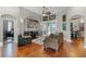 Open-concept living room with ample seating and hardwood flooring at 5740 Aloma Woods Blvd, Oviedo, FL 32765