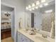 Main bathroom features dual sinks, a large mirror, and access to the main bedroom and water closet at 5740 Aloma Woods Blvd, Oviedo, FL 32765