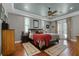 Comfortable main bedroom with hardwood floors, ceiling fan, area rugs and french doors to the outdoor patio at 5740 Aloma Woods Blvd, Oviedo, FL 32765