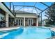 Inviting screened-in pool with brick patio and covered outdoor seating area, perfect for relaxing and entertaining at 5740 Aloma Woods Blvd, Oviedo, FL 32765