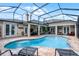 Beautiful in-ground pool with screened enclosure and brick patio, offering a private backyard oasis at 5740 Aloma Woods Blvd, Oviedo, FL 32765