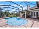 Sparkling in-ground pool featuring a screened enclosure and brick patio, perfect for outdoor enjoyment at 5740 Aloma Woods Blvd, Oviedo, FL 32765