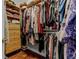 Spacious walk-in closet with built-in shelves, drawers, hanging racks and hardwood floor at 5740 Aloma Woods Blvd, Oviedo, FL 32765
