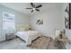 Cozy bedroom with a bed, a side table, and a chair with a side table at 63 W 10Th St, Apopka, FL 32703