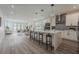 Spacious open-concept kitchen with white cabinets, stainless steel appliances, large island, and views of the living area at 63 W 10Th St, Apopka, FL 32703