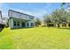 Large, green backyard featuring a covered patio, perfect for outdoor gatherings at 6925 Trellis Vine Loop, Windermere, FL 34786