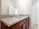 Bathroom showcasing granite countertops, double sinks, and wooden cabinets at 6925 Trellis Vine Loop, Windermere, FL 34786