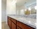 Bathroom featuring a double sink vanity with granite countertops and tile flooring at 6925 Trellis Vine Loop, Windermere, FL 34786